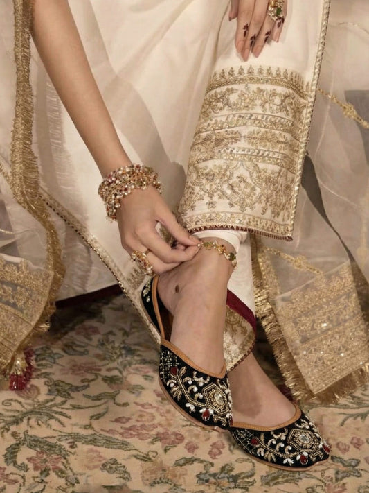 Sahiba black velvet royal zari and mirror work bridal juttis worn with white sharara — handcrafted genuine leather juttis by Solemates by Palak