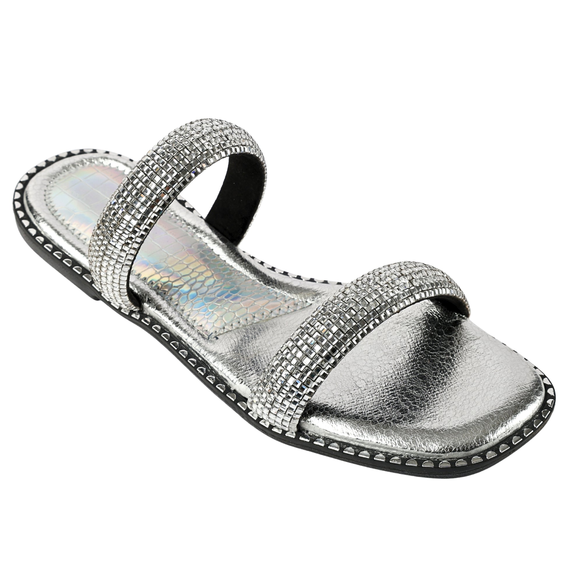 Angled view of Crystalline Silver Flats by Solemates by Palak — double rounded strap flat sandal with fully crystal-set silver straps, holographic inner lining and silver stud sole trim, white background