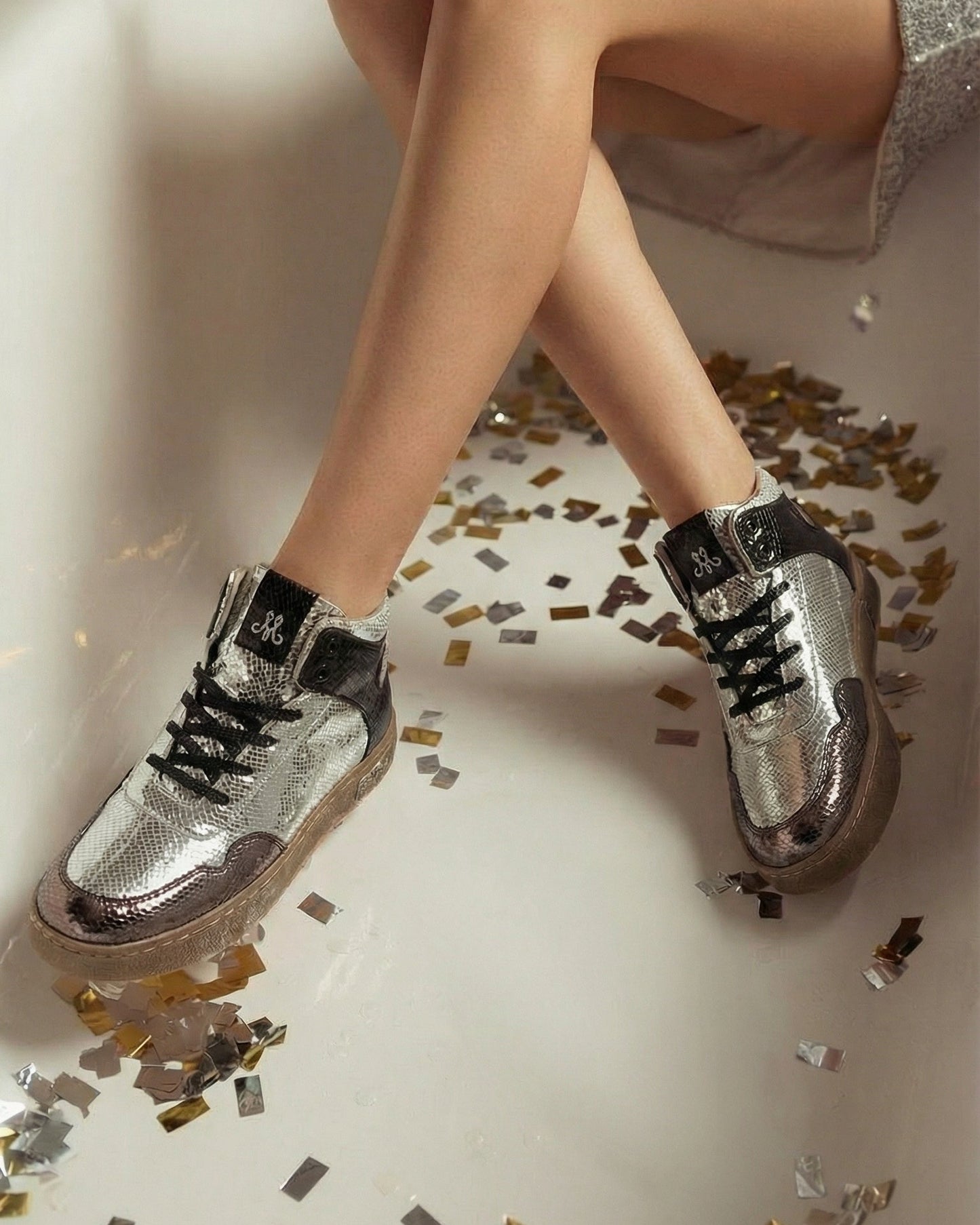 Silver Vortex high-top metallic snake texture sneakers worn with silver sequin dress at party — Solemates by Palak