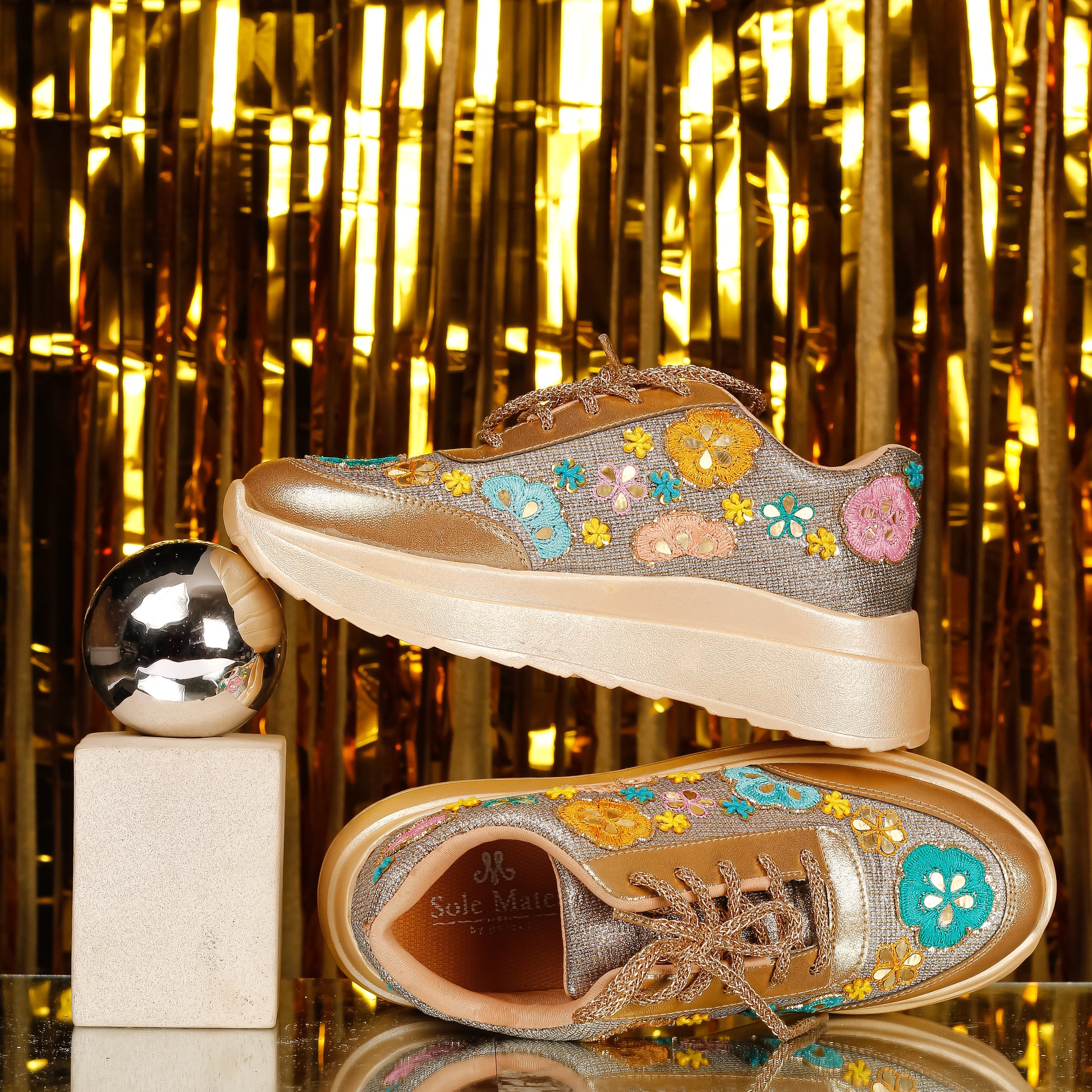 Golden Garden Floral Embroidered Sneakers styled against gold backdrop — multicolour flower appliqués with mirror work by Solemates by Palak