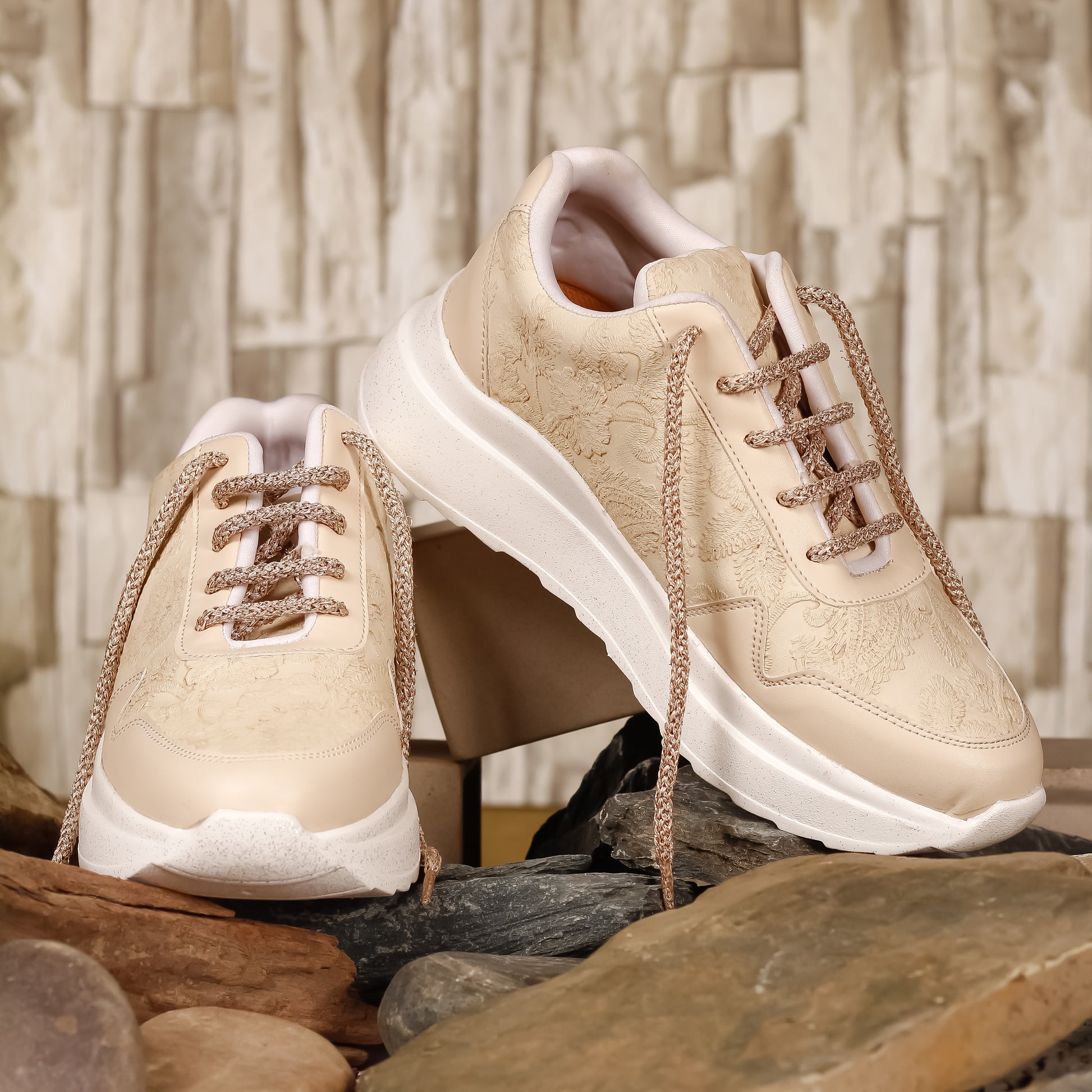 Ivory Elegance Textured Sneakers pair on rocks — cream ivory dual-texture PU with rose gold laces by 
Solemates by Palak