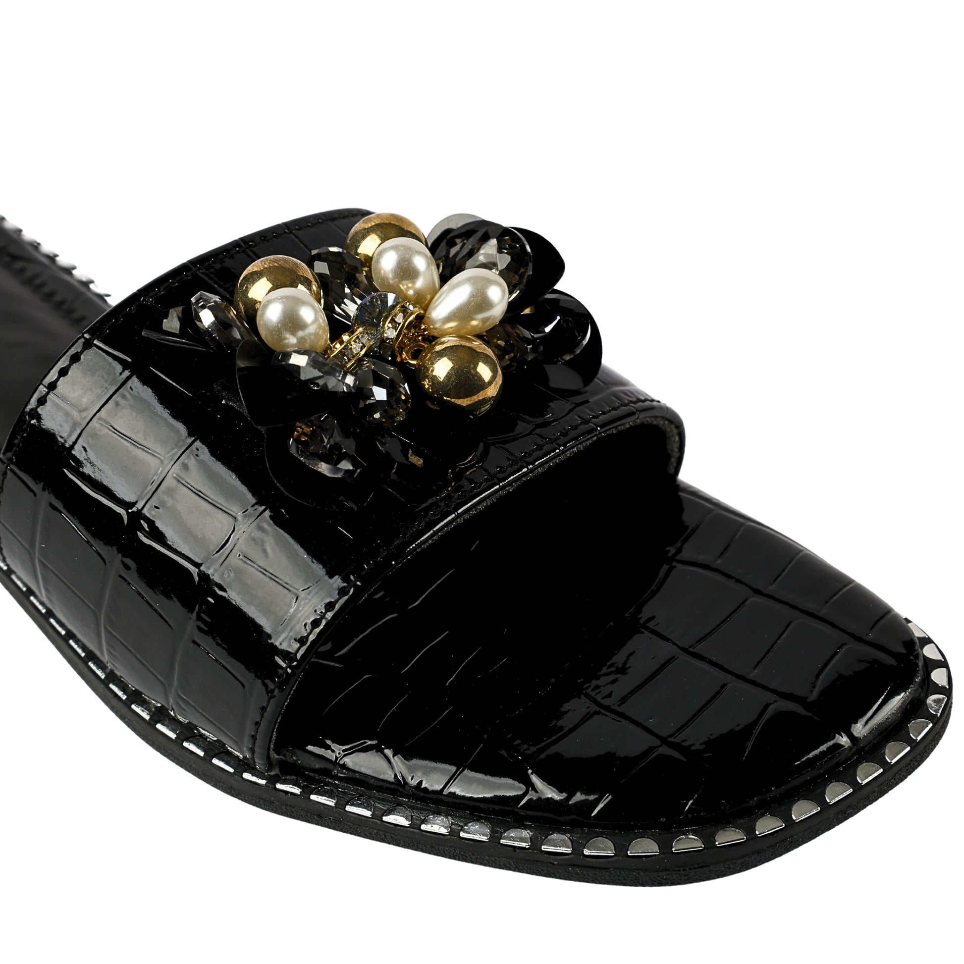 Topaz Black Flat Sliders brooch and sole close-up — white pearl drops, gold ball beads, smoky crystals and black stones on black patent croc strap with silver sole studs by Solemates by Palak