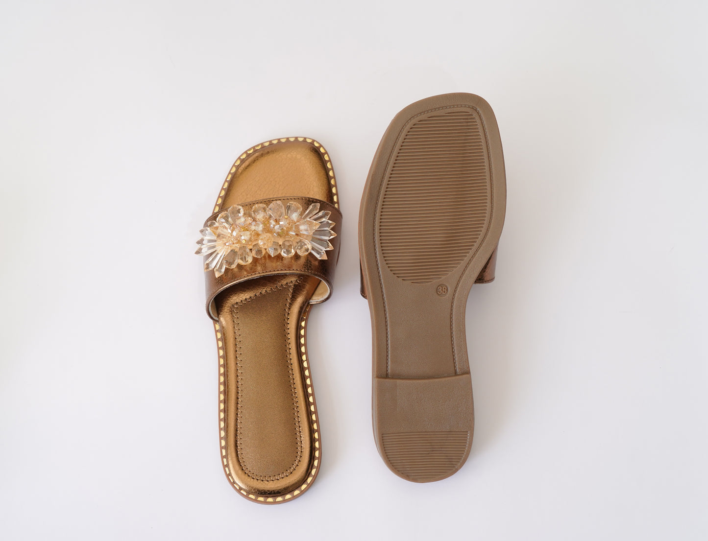 Top and sole view of Copper Mirage slider by Solemates by Palak — copper metallic insole, gold stud trim and handcrafted brown rubber outsole, white background