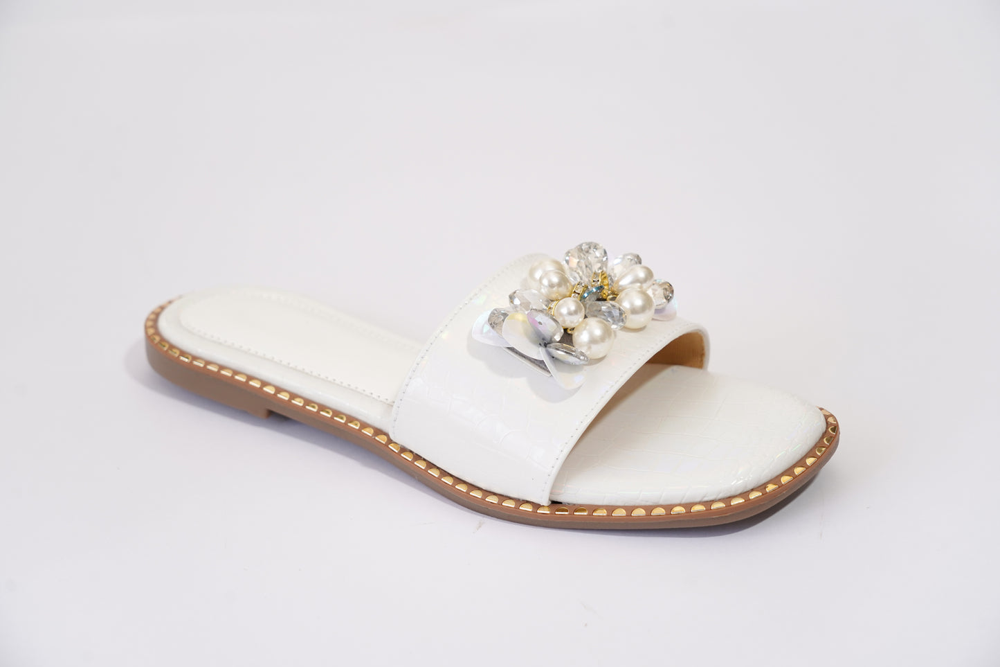 Side profile of Topaz White ivory flat slider — croc-embossed upper with pearl and crystal embellishment, gold stud sole edge, by Solemates by Palak