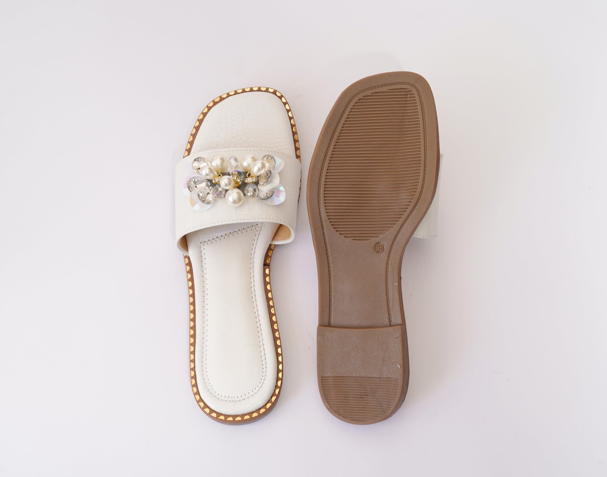 Top and sole view of Topaz White slider by Solemates by Palak — cushioned insole and handcrafted brown rubber outsole with gold stud trim