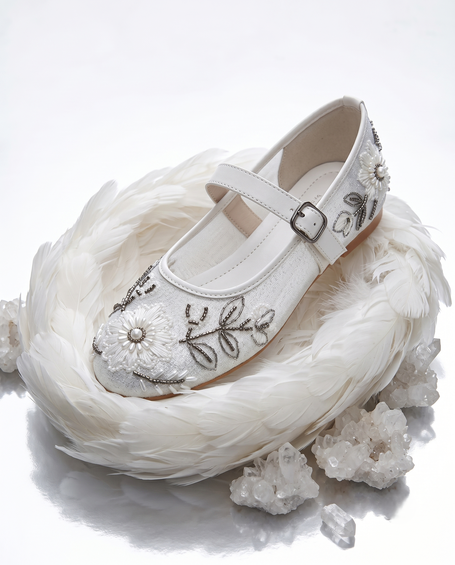The Ballet Bloom Mary Janes nestled in white feathers with crystals — ivory shimmer Mary Jane with hand-embellished floral threadwork and pearl beads by Solemates by Palak