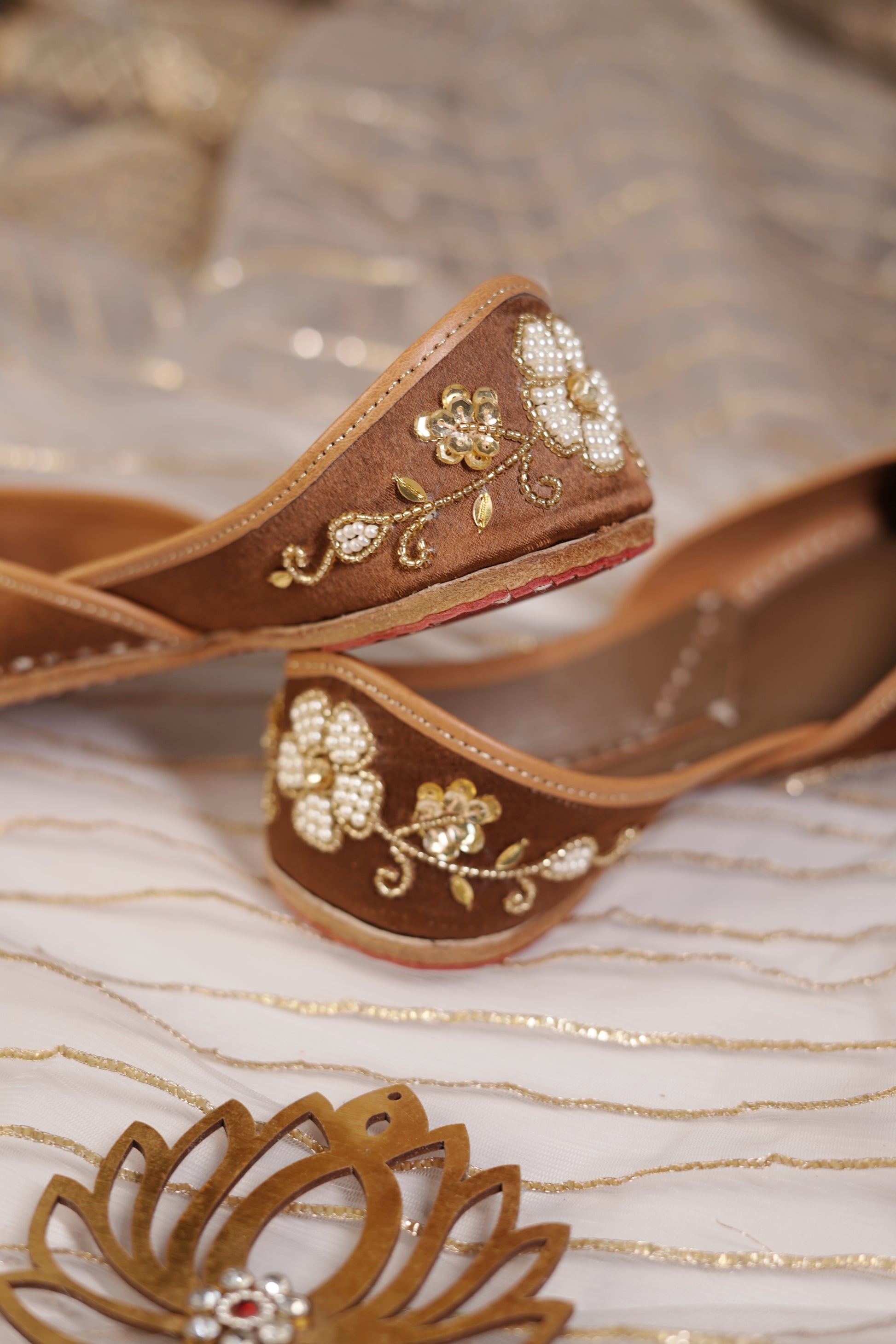 Mocha Juttis side and sole detail — tan leather border with pearl and gold embellishments by Solemates by Palak
