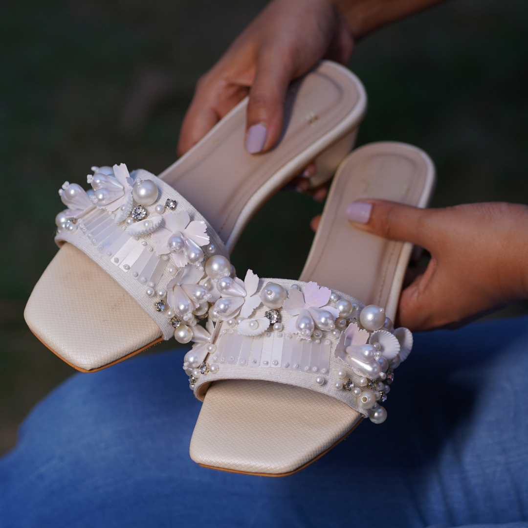 Close-up of Bombshell Handcrafted Heel Sliders — pearl clusters, 3D floral appliques, sequin bars and rhinestone accents on ivory strap by Solemates by Palak