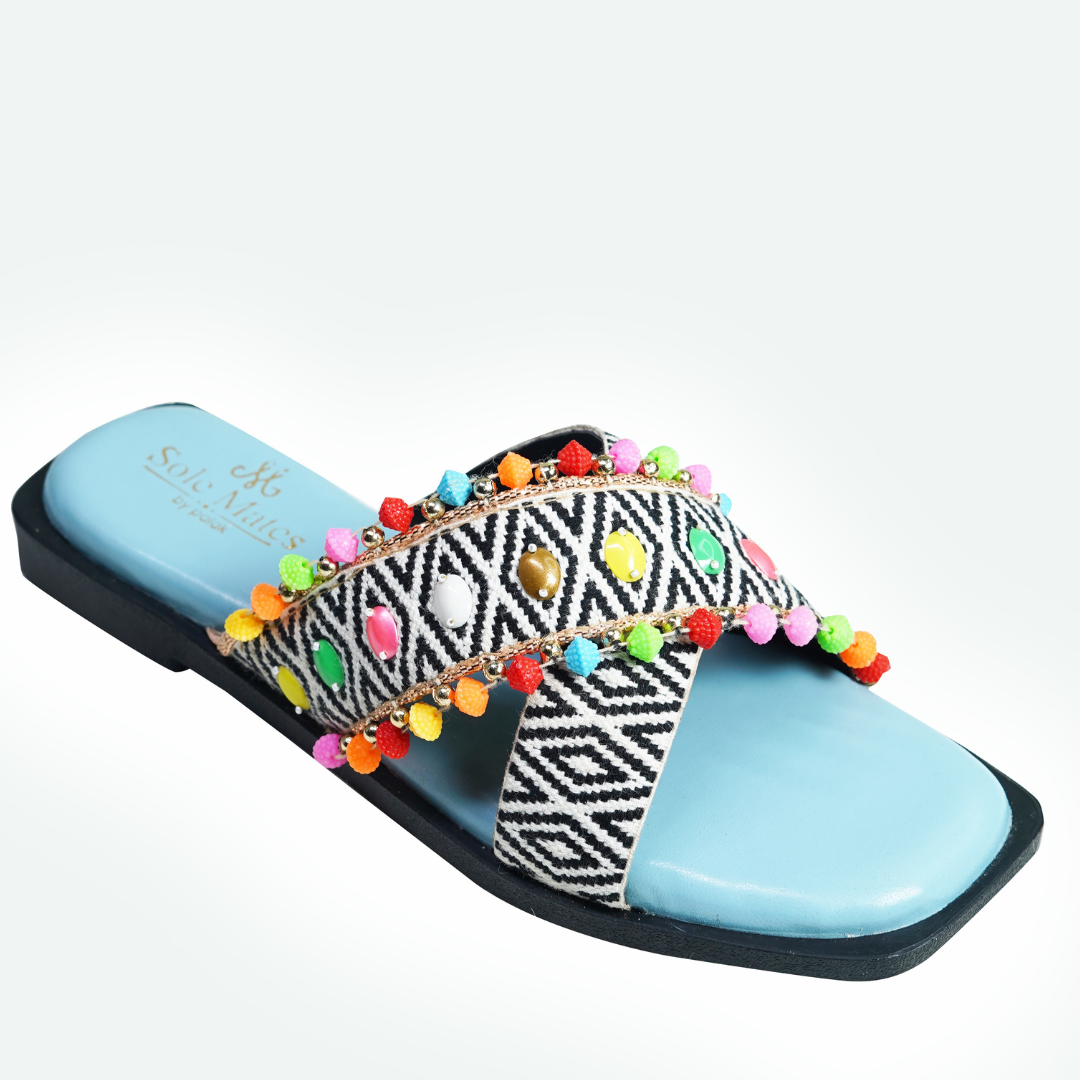 Mykonos Criss Cross Sliders side profile white background — ikat diamond woven cross strap with colourful pom pom fringe and sky blue insole by Solemates by Palak